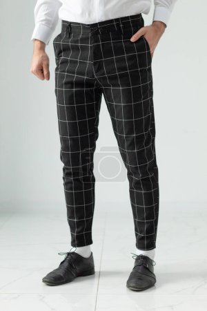 Photo for Bulgaria - 03 19 2024: Black pants for male with white stripes. Modeling. - Royalty Free Image