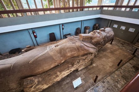 Photo for Memphis, Egypt - January 2, 2024: A monumental statue of Ramesses II carved from limestone and measuring about 10 metres in length - Royalty Free Image