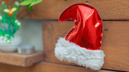 Téléchargez les photos : Célébration de Noël confortable, festive et joyeuse avec ornements rouges et chapeau de Père Noël. - en image libre de droit
