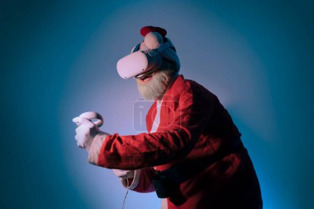 Photo for Santa wear vr helmet gadget device equipment  watching realistic experience. Elderly gray-haired mustache bearded Santa Claus experiencing virtual reality playing in video game - Royalty Free Image