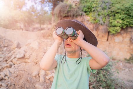 Photo for Funny boy kid little tourist boy with binoculars - Royalty Free Image