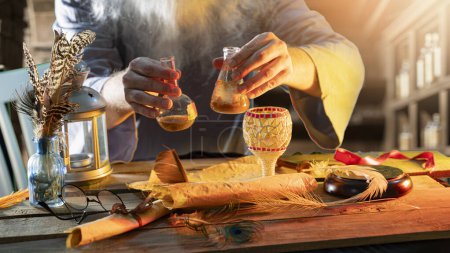 Der Tisch des Alchemisten und seine Hände in Großaufnahme in einem mittelalterlichen Chemielabor