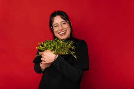 Photo of happy smiling young trendy woman holding bunch of microplants, Healthy Food.