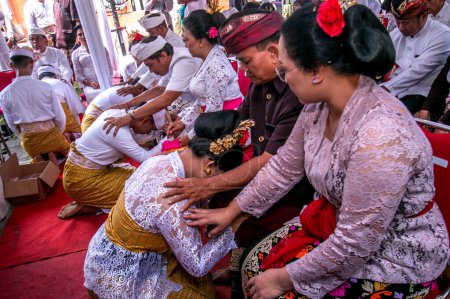 Photo for Participants carry out a series of rituals before the tooth-cutting process or the Mepandes tradition is carried out at the Giri Kusuma Temple Pasraman, Bogor City, West Java, Indonesia, on July 9 2023 - Royalty Free Image