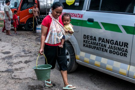 Photo for Bogor, Indonesia - August 07, 2023: Residents in Bogor, West Java, who are affected by drought and lack of clean water due to the dry season receive clean water assistance from the government - Royalty Free Image