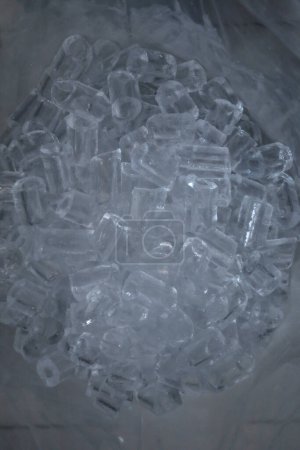 Photo for Crystal ice cube pieces in a white plastic bag - Royalty Free Image