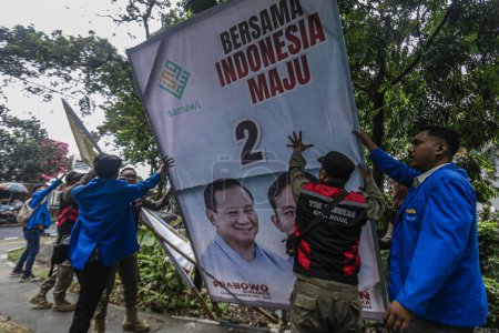 Photo for Officers remove visual media campaigning for political parties in Bogor City, West Java on January 23, 2024. - Royalty Free Image