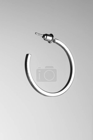 Jewelry close up, gray background, silver, earring, circle earring