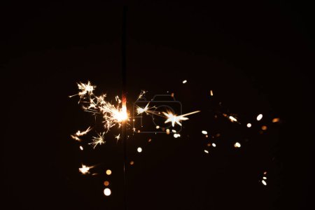 Photography, sparkler close-up on a dark background, holiday lights