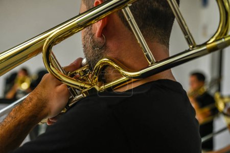 Photo for Mans hands playing the trombone in the orchestra - Royalty Free Image
