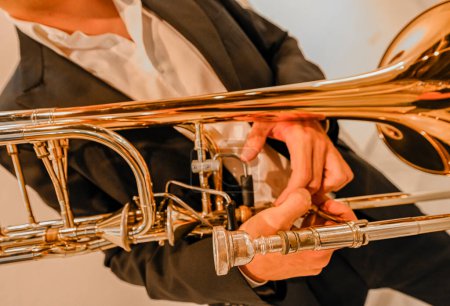 Photo for Mans hands playing the trombone in the orchestra - Royalty Free Image