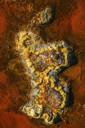 A detailed view of the multi-colored mineral deposits found in the Rio Tinto riverbed