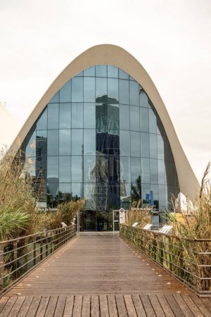 A captivating view of Oceanografic Valencia's reflective glass facade, creating an archway that mirrors the city's skyline