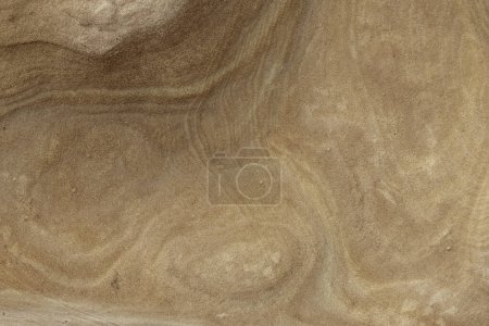 Close-up of a smooth sandstone surface featuring subtle natural patterns and textures. Perfect for backgrounds, nature themes, and geological studies.