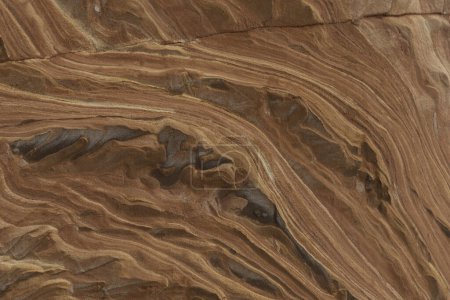 Close-up of intricate sandstone swirls and erosion patterns, highlighting the natural beauty and texture of sedimentary rock formations. Perfect for geological themes and backgrounds.