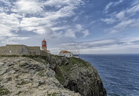 The iconic Saint Vincent Lighthouse perched on the rocky cliffs of Cabo de Sao Vicente in Portugal.