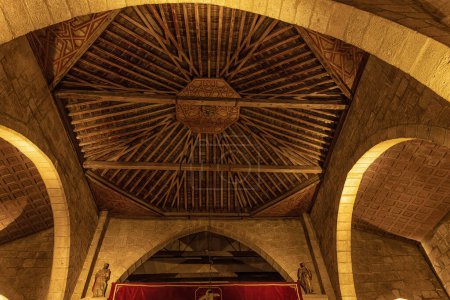 Detailed view of the intricate wooden ceiling inside the Basilica of Santa Eulalia in Merida, Spain.