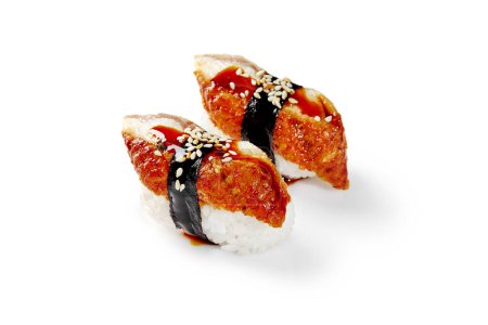 Photo for Two delicious nigiri sushi with eel slices wrapped with nori strip topped with unagi sauce and sesame isolated on white background. Japanese cuisine - Royalty Free Image