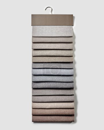 Téléchargez les photos : Collection of natural upholstery fabric samples in beige and gray tones for soft comfortable furniture, designer curtains or sturdy homewares. Interior color choice concept - en image libre de droit
