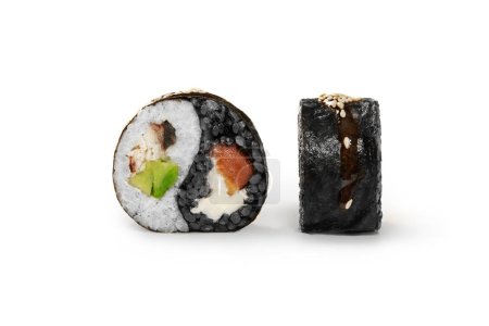 Apetitivo rollo de sushi en forma de yin y yang símbolo con arroz blanco y negro lleno de salmón, anguila, aguacate y queso crema cubierto con salsa unagi y semillas de sésamo tostadas. Cocina japonesa