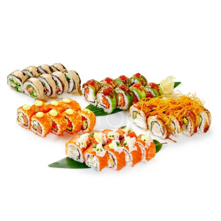 Diverse collection of specialty sushi rolls with salmon, eel and shrimp, garnished with fish roe, spicy mayo, and crispy strands, artfully arranged on bamboo leaves with traditional accompaniments