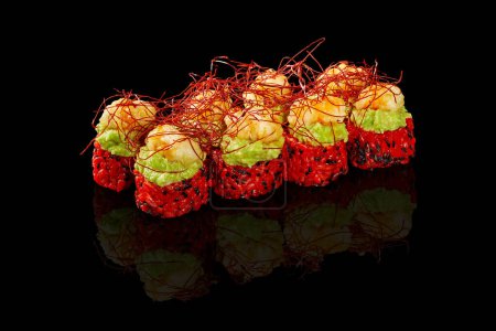 Enticing vibrant red rice sushi rolls topped with avocado spread and shrimp tempura garnished with spicy togarashi threads, presented on black background. Japanese menu concept
