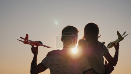 Photo for Children play with toy airplanes. Girl with big brother have fun. - Royalty Free Image