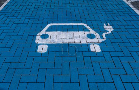 Photo for White electric vehicle symbol on blue floor of a charging station - Royalty Free Image