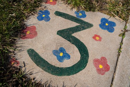 Photo for Hopscotch game painted by children on the playground with a green number 3 and coloful flowers - Royalty Free Image