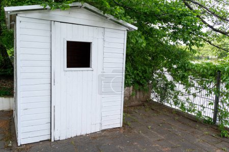 Small white shed by the lake