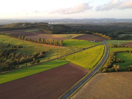 Aerial view of a countryside with fields and a road