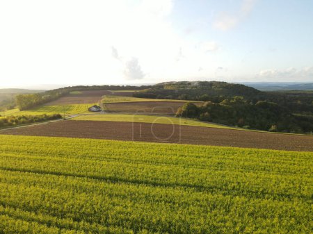 View from above of a countryside with country fields during sunset