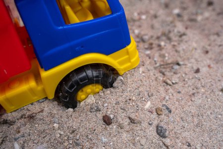 Children toy truck in the sand