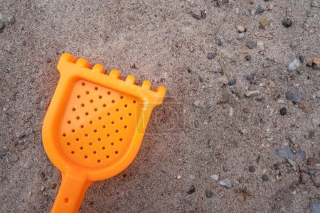 Toy rake for children in the sand 
