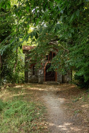 Orthodox, Christian, stone church in the mountains in the forest on a sunny summer day (Greece; Pelion)