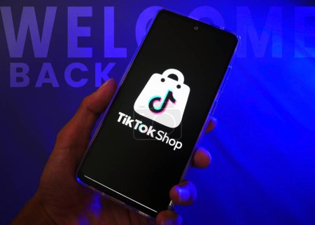 Photo for Hand holding a smartphone with TikTok shop. Popular marketplace in worldwide. e-commerce social media commerce - Royalty Free Image