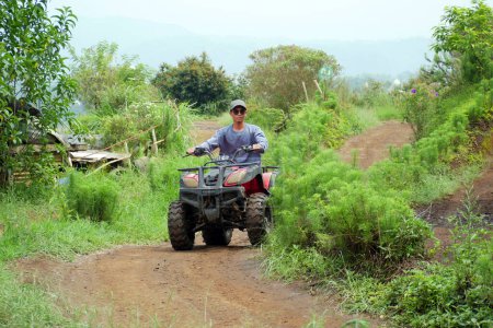 Photo for Asian man playing ATV Ride Adventure Tour in Malang, Indonesia - Royalty Free Image