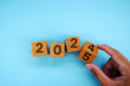 Photo for Hand flipping block 2024 to 2025 text on table. Resolution, time, plan, goal, motivation, reboot, countdown and New Year holiday concepts - Royalty Free Image