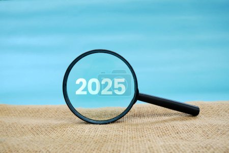 Photo for Magnifying glass and targets 2025. Concept of new year 2025, beginning of success, challenge or career path, change, planning, goals, challenges and new year resolutions. - Royalty Free Image