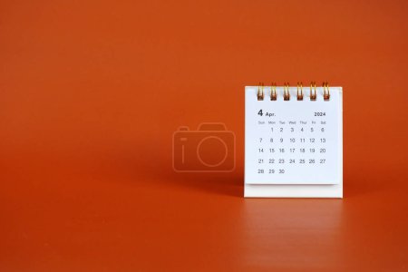Photo for April 2024 month calendar on soft red background - Royalty Free Image