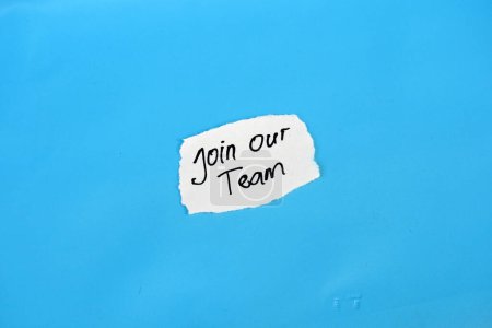 Join our team text on torn notepaper isolated on blue background