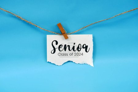 Paper stapled to string with the words Senior class of 2024