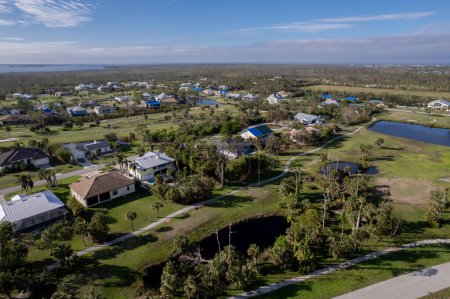 Photo for Hurricane Ian destroyed homes in Florida residential area on golf course. Natural disaster and its consequences - Royalty Free Image