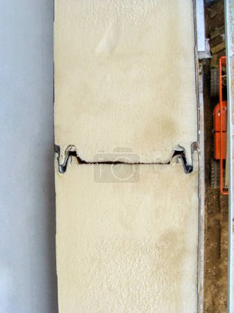 PIR-isolierte Sandwichpaneele an einer Hausfassade, die das Verbindungsschloss zeigen. Nahaufnahme von PIR-Isolierpaneelen