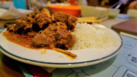 Photo for Closeup of Spicy Rogan josh mutton or goat curry with aromatic Basmati rice or Chawal - Royalty Free Image