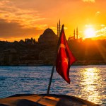 Turkey flag and sunset in front of the Suleymaniye Mosque.