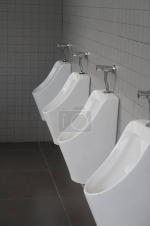 Photo for White ceramic and steel comfort male toilet urinals - Royalty Free Image