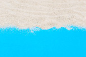 Sand on blue background. Copy space for text.  Poster #652529598