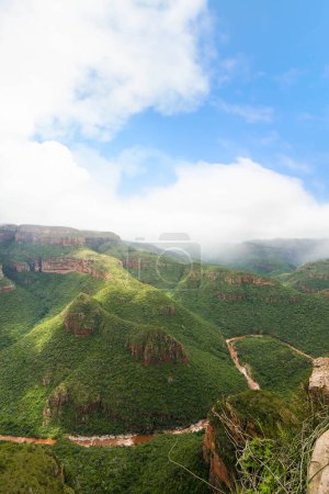 A stunning image capturing the panoramic beauty of the green mountain range in Drakensberg, South Africa.