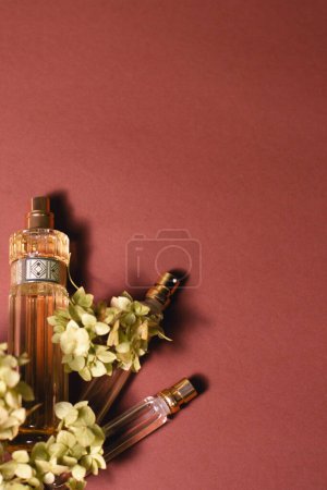 Hydrangea with perfume on a brown background